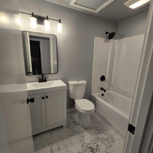 White bathroom with marbled flooring
