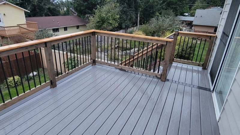 2 story deck with composite decking and a cedar railing with black aluminum balusters
